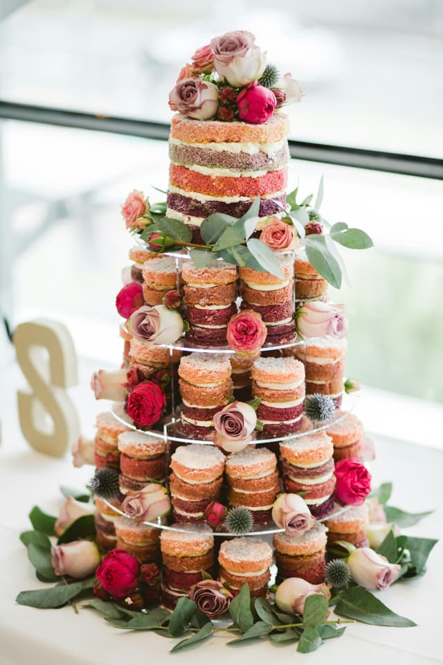 We will work with you to create a personalized display tailored to match the size and style of your wedding. We can also create a unique multi-layered wedding cake to be placed on the top tier. The flowers you see on top of this sample are made to order (in this case to match the bride's bouquet) in our shop.